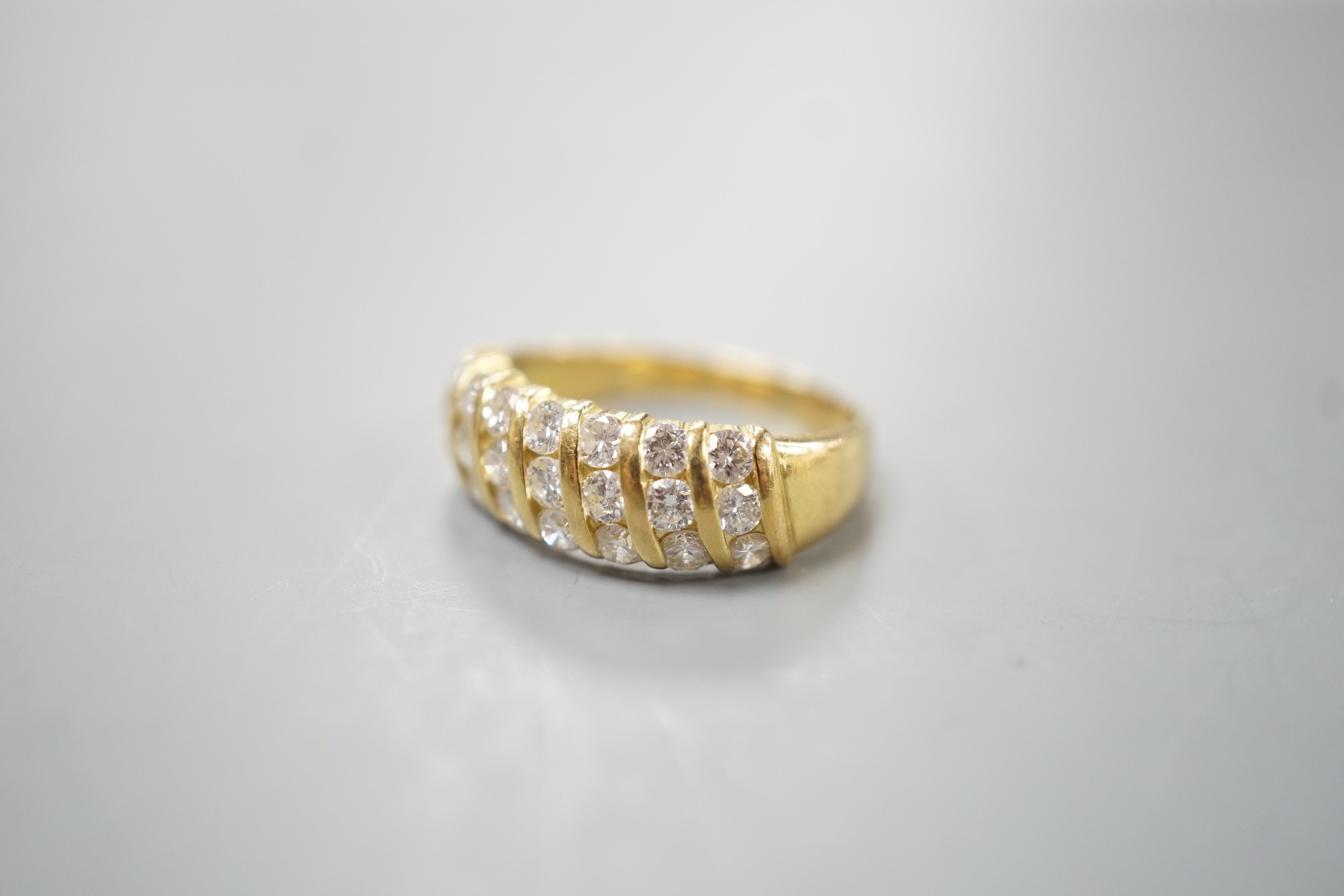 A modern 18ct gold and twenty one stone diamond set seven row half hoop ring, size N, gross weight 4.5 grams.